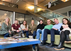 PharmaLedger team in the Basel Switzerland office sitting on a couch.