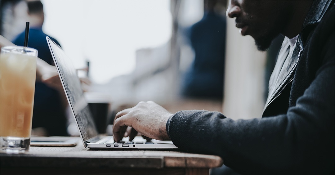 Businessman working remotely from a cafe.